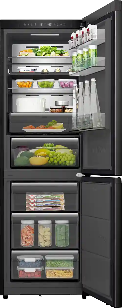 Czarna lodówka z otwartymi drzwiami, ukazująca wnętrze z półkami wypełnionymi różnorodnymi produktami spożywczymi, w tym warzywami, napojami i pojemnikami z jedzeniem. Na górnej półce widoczne są butelki i kartony, a na dolnych pojemniki z mrożonkami i świeżymi produktami.