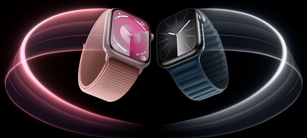Na obrazie znajdują się dwa smartwatche z wyświetlonymi tarczami, jeden z różowym paskiem i różowym tłem, drugi z niebieskim paskiem i czarnym tłem. W tle widoczne są kolorowe, świetliste okręgi.