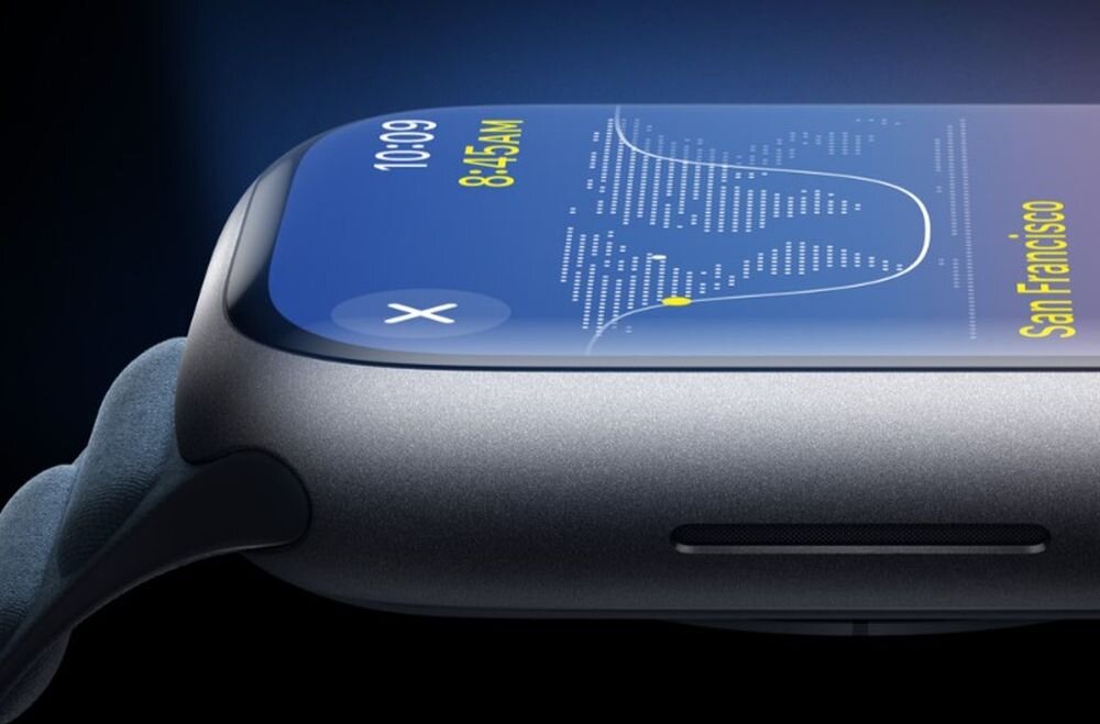 Zbliżenie na bok srebrnego zegarka z wyświetlaczem pokazującym godzinę 10:09 i napis \'San Francisco\'. Pasek zegarka jest w kolorze sztormowego błękitu.