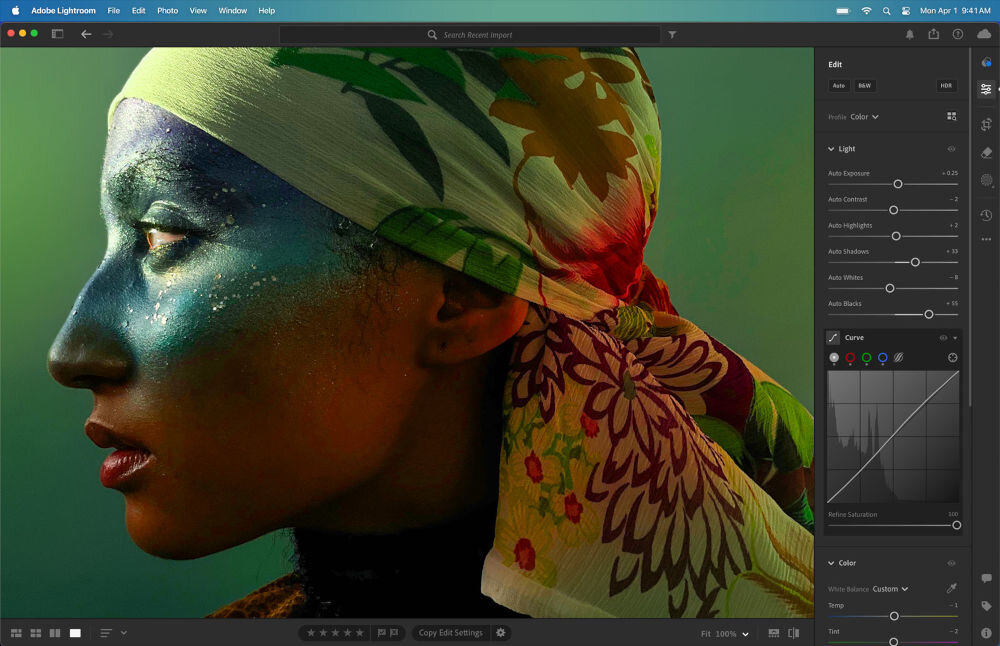 Ekran programu Adobe Lightroom z edytowanym zdjęciem osoby z kolorowym makijażem i chustą w kwiaty. Po prawej stronie widoczne są suwaki do edycji parametrów obrazu, takich jak jasność i kontrast.