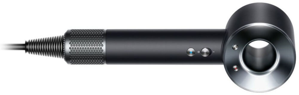 Suszarka do włosów Dyson Supersonic leżąca płasko, widoczny filtr u dołu rączki i wloty powietrza