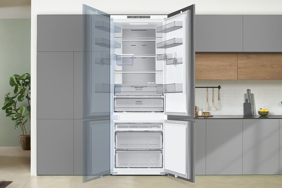 Dodatkowe cechy: Przekładane drzwi - Samsung lodówka z zamrażalnikiem BRB38G705DWW Otwarta lodówka z widocznymi półkami i szufladami, umieszczona w nowoczesnej kuchni. Na drzwiach lodówki widoczne są przezroczyste półki.