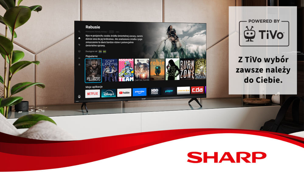 Telewizor wyświetla ekran z aplikacjami takimi jak Netflix, Disney+, YouTube, HBO Max i Player. Obok znajduje się napis \'POWERED BY TiVo\' oraz \'Z TiVo wybór zawsze należy do Ciebie.\' z logo TiVo i logo SHARP na dole.
