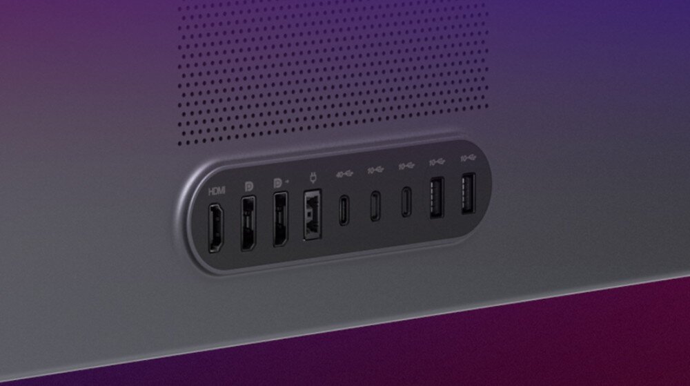 Obraz przedstawia panel złącz na urządzeniu, zawierający porty HDMI, USB-C, USB-A oraz Ethernet. Nad panelem widoczne są otwory wentylacyjne.