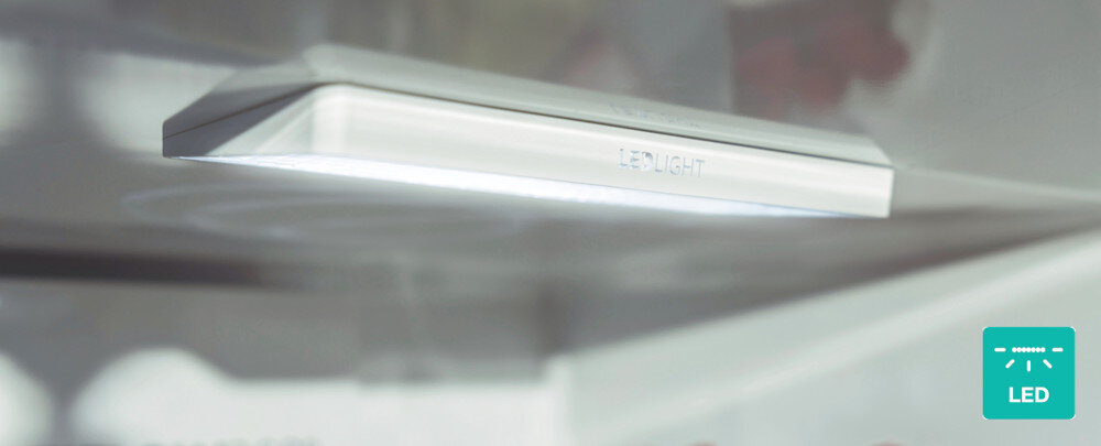 Obraz przedstawia wewnętrzne oświetlenie LED w lodówce, z napisem \'LED LIGHT\' na obudowie. W prawym dolnym rogu znajduje się ikona z napisem \'LED\'.