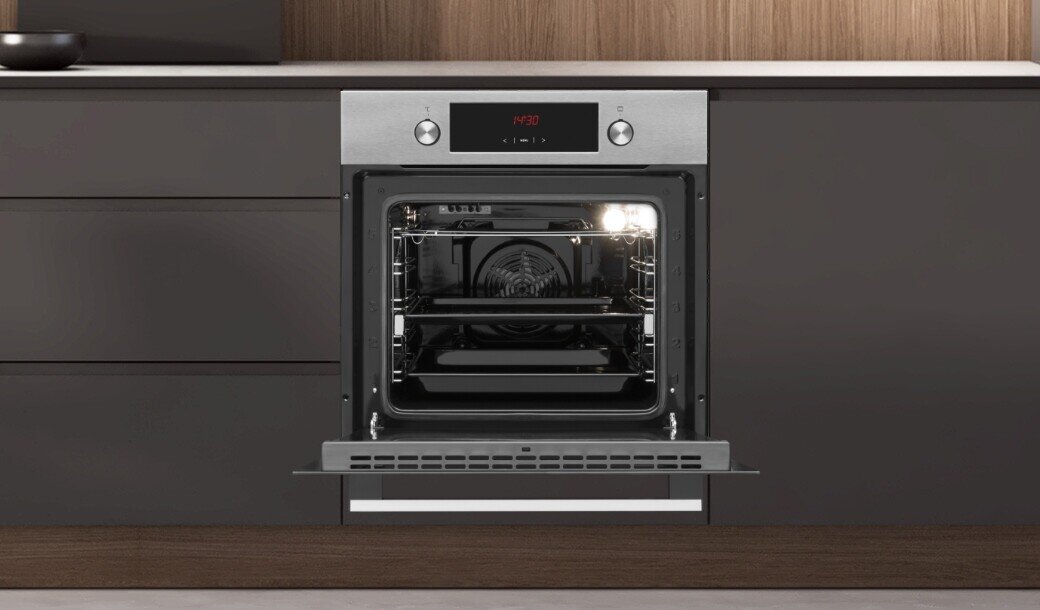 Otwarty piekarnik w zabudowie kuchennej z widocznym wnętrzem i oświetleniem. Na panelu sterowania wyświetla się czas \'12:30\'.