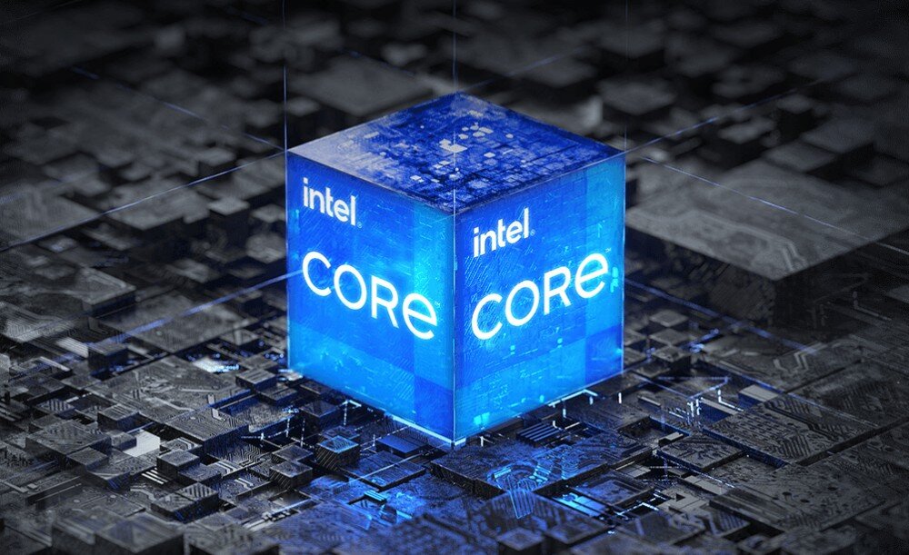 Obraz przedstawia niebieski sześcian z napisem \'intel CORE\' na tle przypominającym układ scalony. Sześcian emituje jasne, niebieskie światło.