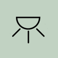 Ikona przedstawia czarny symbol lampy na jasnym tle.