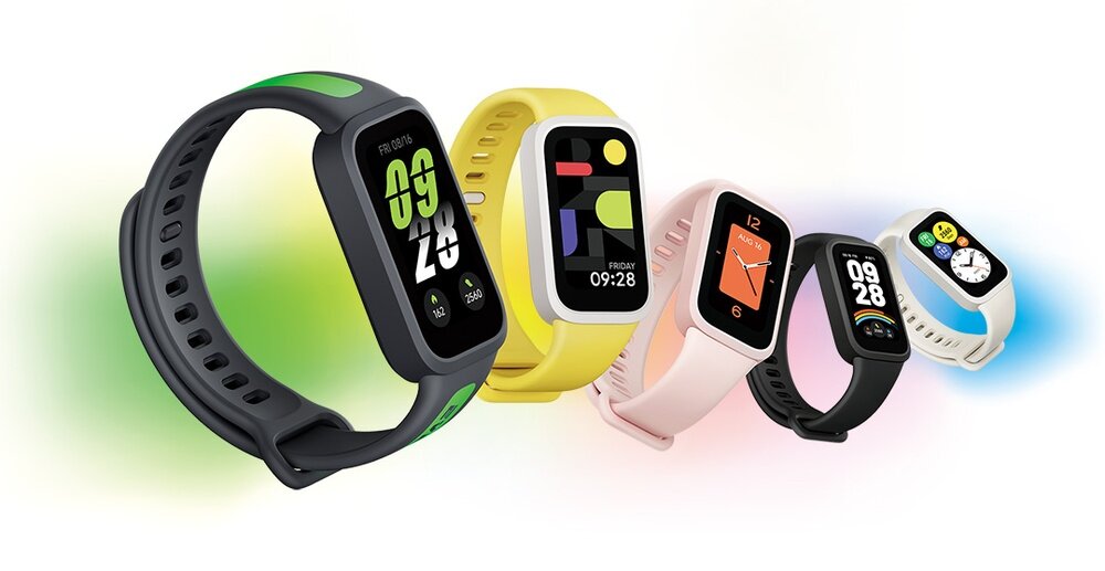 Na obrazie widoczne są różnokolorowe smartbandy z wyświetlaczami pokazującymi różne tarcze zegara. Każdy smartband ma inny kolor paska, w tym czarny, żółty, różowy, biały i zielony.