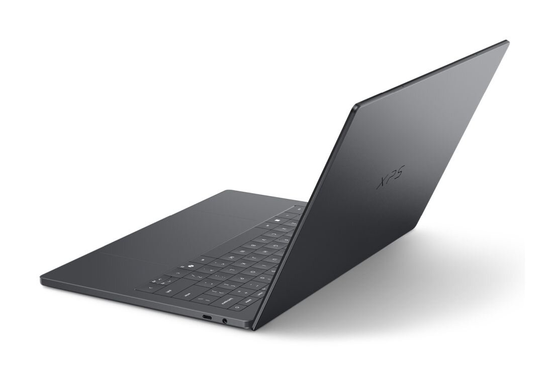 Laptop Dell XPS 14 z aluminiową obudową prezentuje smukłą konstrukcję na jasnym tle podczas mobilnej pracy biznesowej
