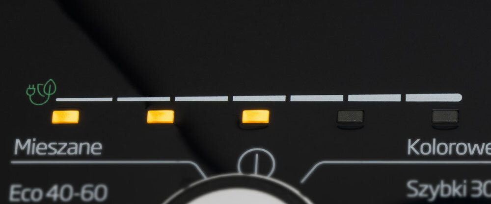 Panel sterowania pralki z widocznymi podświetlonymi przyciskami i ikoną wtyczki. Widoczne napisy: \'Mieszane\', \'Eco 40-60\', \'Kolorowe\', \'Szybki 30\'.