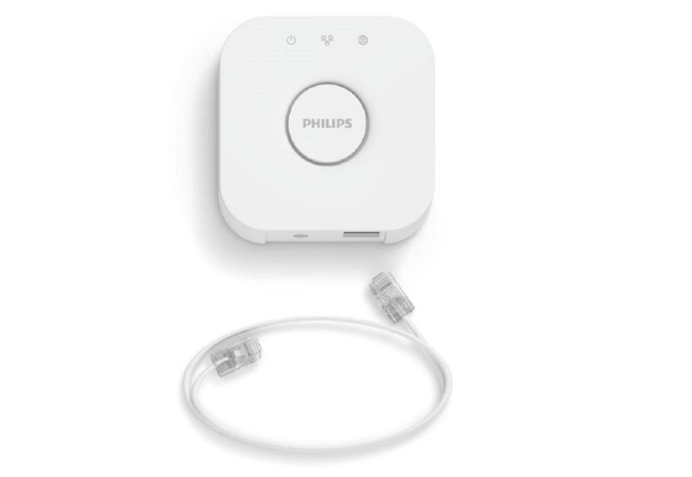Na obrazie widoczna jest biała bramka z logo \'PHILIPS\' na środku oraz trzy ikony na górze. Obok znajduje się biały kabel z wtyczkami RJ-45 na obu końcach.