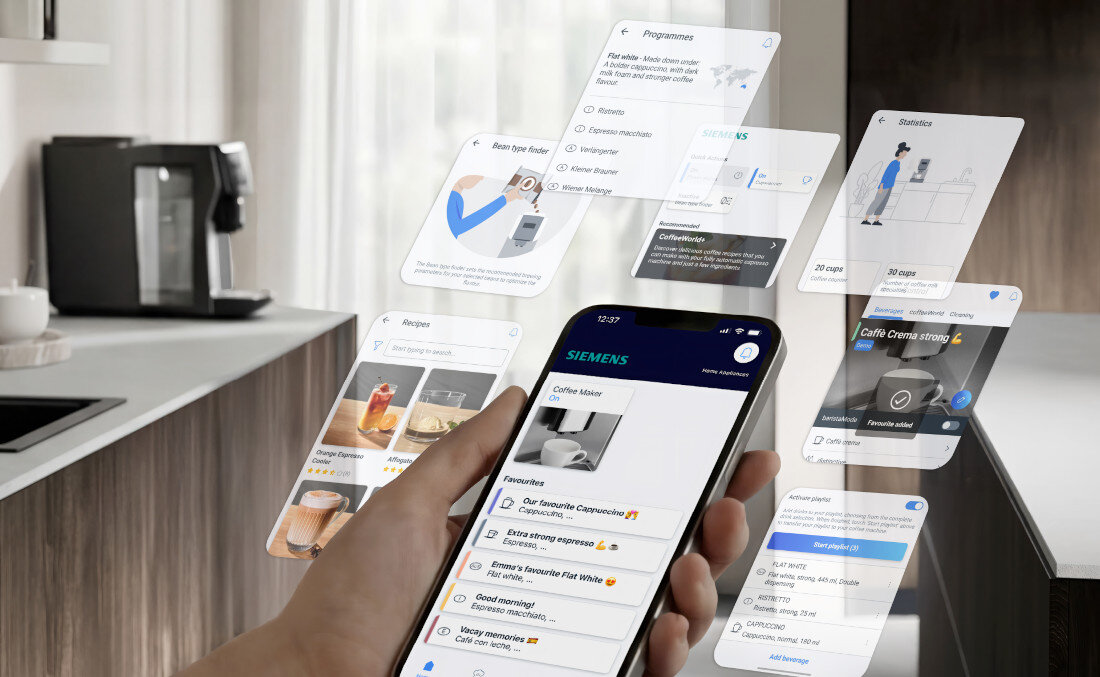 Osoba trzyma smartfon z aplikacją SIEMENS, na ekranie widoczne są różne opcje dotyczące kawy. W tle znajduje się ekspres do kawy na blacie kuchennym.
