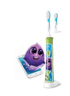 Szczoteczka soniczna z kolorowym wzorem i wymienną główką, obok której znajduje się animowana postać na tle smartfona. Produkt jest przeznaczony dla dzieci i ma przyjazny, kolorowy design.