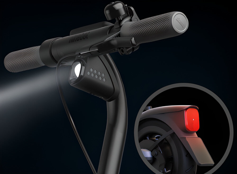 Czarna hulajnoga elektryczna z widocznym przednim światłem i uchwytem kierownicy. W okrągłym powiększeniu pokazano tylne czerwone światło na błotniku.