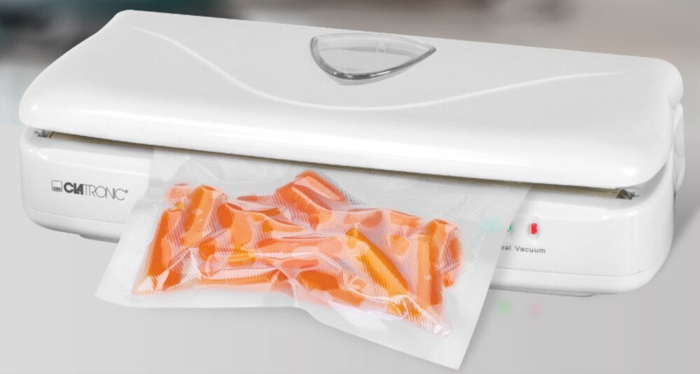 Na obrazie widoczna jest biała zgrzewarka z logo \'CLATRONIC\', z której wystaje worek z pomarańczowymi przedmiotami. Obok logo znajdują się dwa małe wskaźniki świetlne.