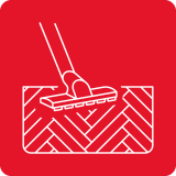 Ikona przedstawia białą grafikę odkurzacza na czerwonym tle, symbolizującą czyszczenie podłogi z drewnianym wzorem.