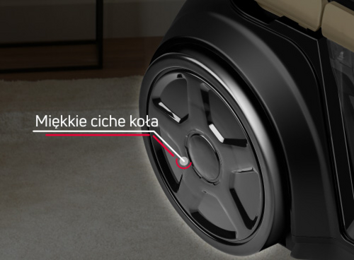 Obraz przedstawia zbliżenie na koło odkurzacza z podpisem \'Miękkie ciche koła\'.