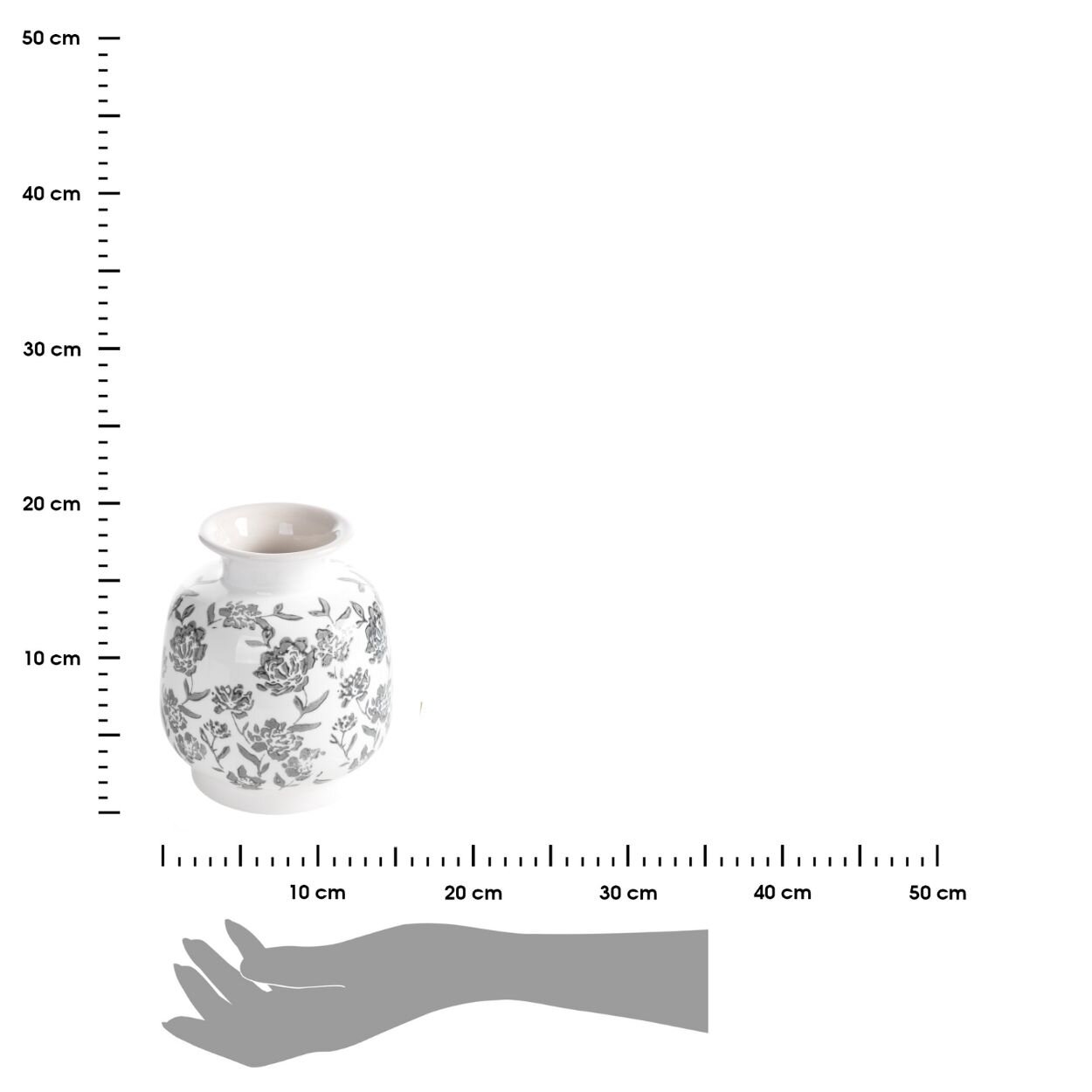 Biały ceramiczny wazon z kwiatowym wzorem, umieszczony na tle z miarką w centymetrach oraz szarą sylwetką dłoni dla porównania wielkości.