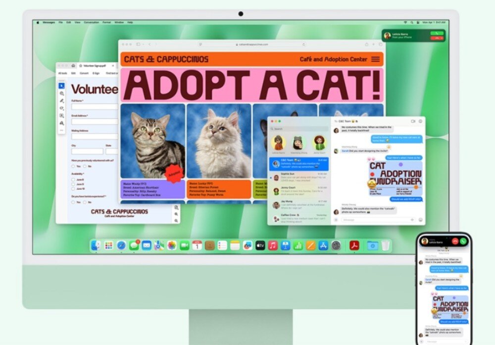 Na ekranie komputera wyświetlone są różne aplikacje, w tym strona internetowa z napisem \'ADOPT A CAT!\' oraz okna komunikatora. Obok monitora znajduje się smartfon z podobnym interfejsem komunikatora.