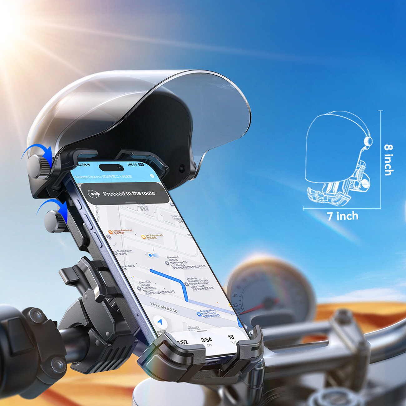 Uchwyt rowerowy na telefon zamontowany na kierownicy roweru, z osłoną przeciwsłoneczną i amortyzacją. Na ekranie telefonu widoczna jest mapa z trasą oraz tekst \'Proceed to the route\'.