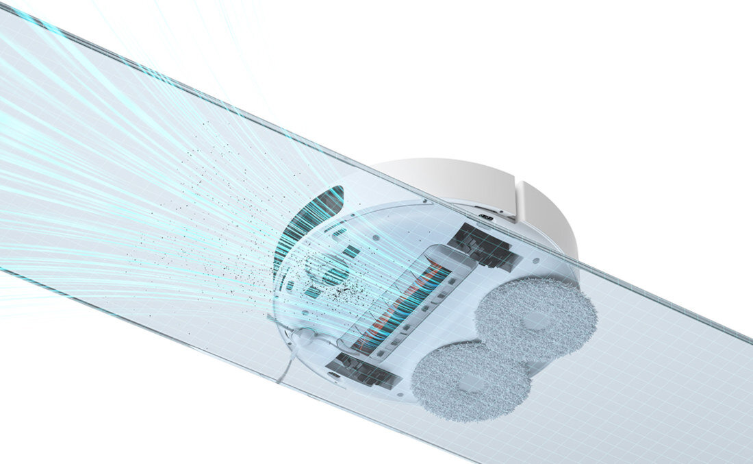 Obraz przedstawia widok od spodu robota sprzątającego z dwoma okrągłymi szczotkami i strumieniami powietrza wskazującymi na działanie ssące. Robot jest umieszczony na przezroczystej powierzchni, przez którą widać jego mechanizmy.