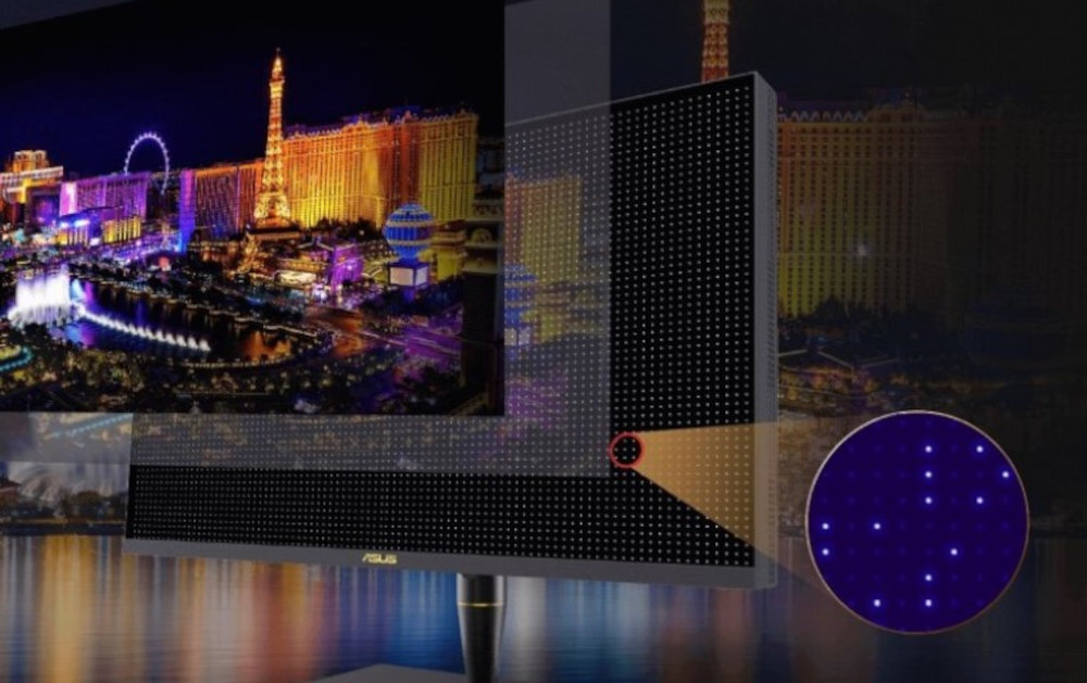 Monitor wyświetla kolorowy obraz nocnego miasta z oświetlonymi budynkami i kołem widokowym. Na obudowie monitora widoczne jest logo ASUS.