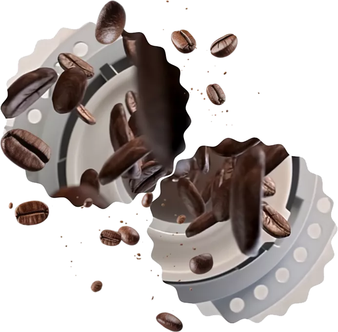 Obraz przedstawia ziarna kawy unoszące się w powietrzu na tle elementu mechanicznego z okrągłymi otworami. Ziarna są w różnych pozycjach, a tło jest rozmyte.