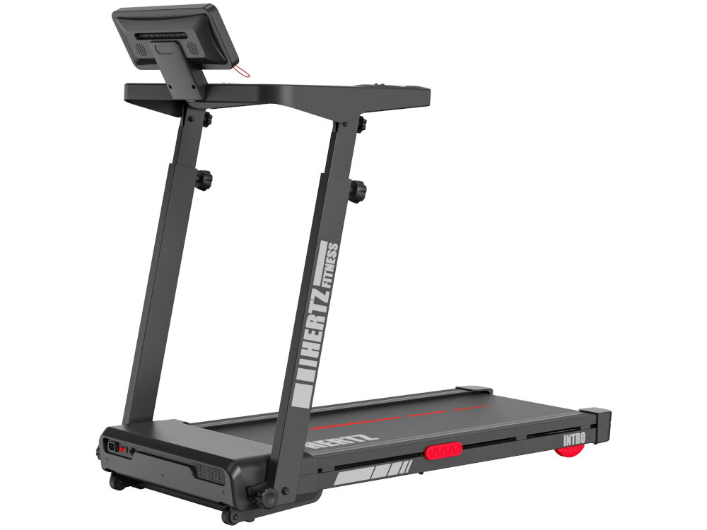 Na obrazie widoczna jest bieżnia elektryczna z logo \'HERTZ FITNESS\' na ramie. Bieżnia ma ciemny kolor z czerwonymi akcentami i wyświetlaczem na górze.
