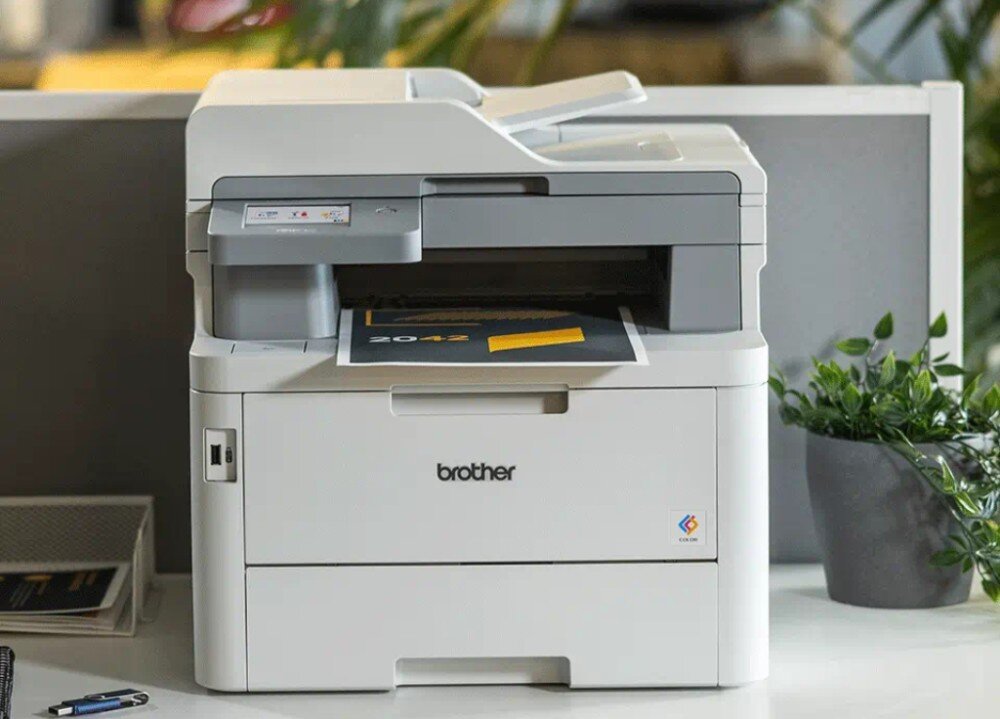 Urządzenie wielofunkcyjne BROTHER MFC-L8390CDW stojące na biurku przodem wygląd opis