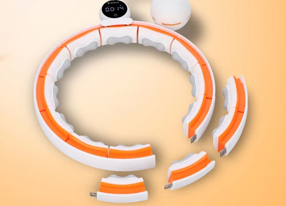 Na obrazie widoczny jest biało-pomarańczowy hula hop z segmentami, które można łączyć. W tle znajduje się pomarańczowe tło, a na jednym z segmentów widoczny jest wyświetlacz z tekstem \'media expert\'.