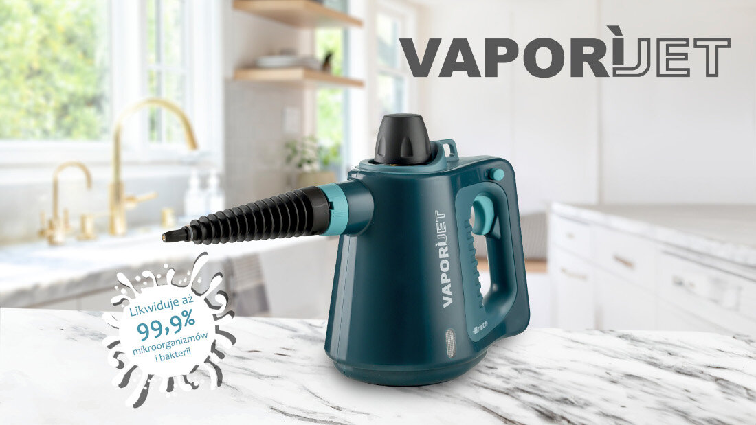 Na blacie kuchennym stoi ciemnoniebieski czyścik parowy z napisem \'VAPORI JET\'. Obok widnieje tekst \'Likwiduje aż 99,9% mikroorganizmów i bakterii\'.