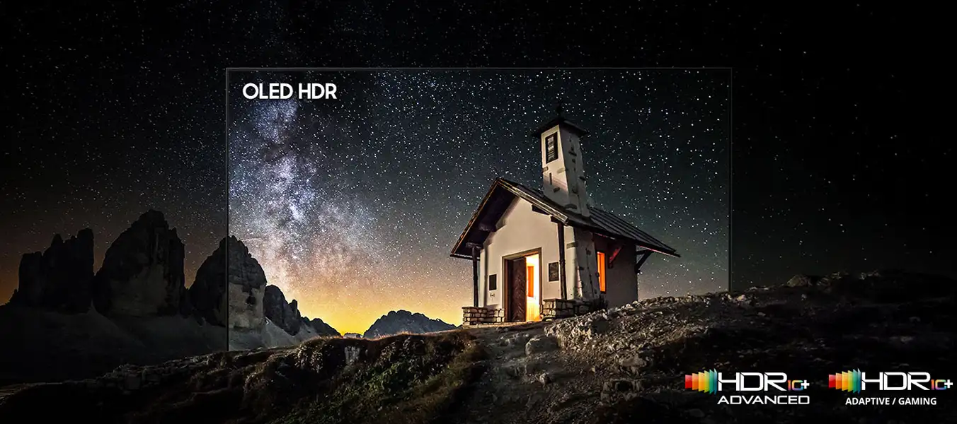 Obraz przedstawia mały domek na tle gwiaździstego nieba z widoczną Drogą Mleczną. Na obrazie widnieje tekst \'OLED HDR\' oraz logotypy \'HDR 10+ ADVANCED\' i \'HDR 10+ ADAPTIVE / GAMING\'.