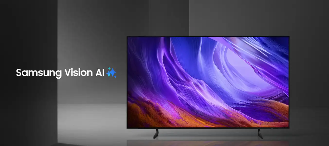 Telewizor z wyświetlaczem pokazującym abstrakcyjny, kolorowy wzór w odcieniach fioletu i pomarańczu. Obok widoczny jest napis \'Samsung Vision AI\'.