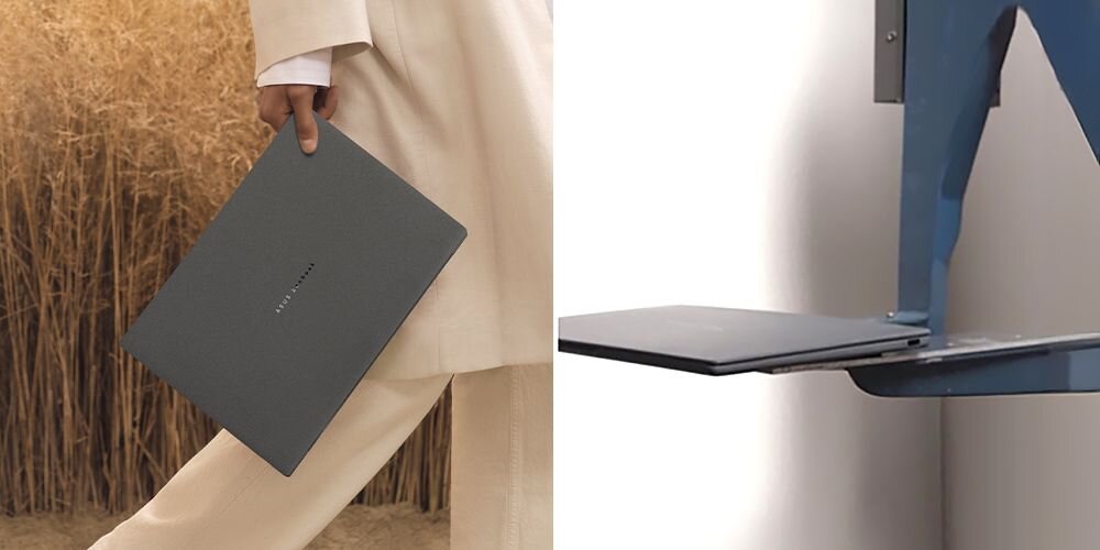 Osoba w jasnym ubraniu trzyma ciemny laptop z widocznym napisem \'ASUS\'. Obok znajduje się metalowy uchwyt na ścianie z półką.