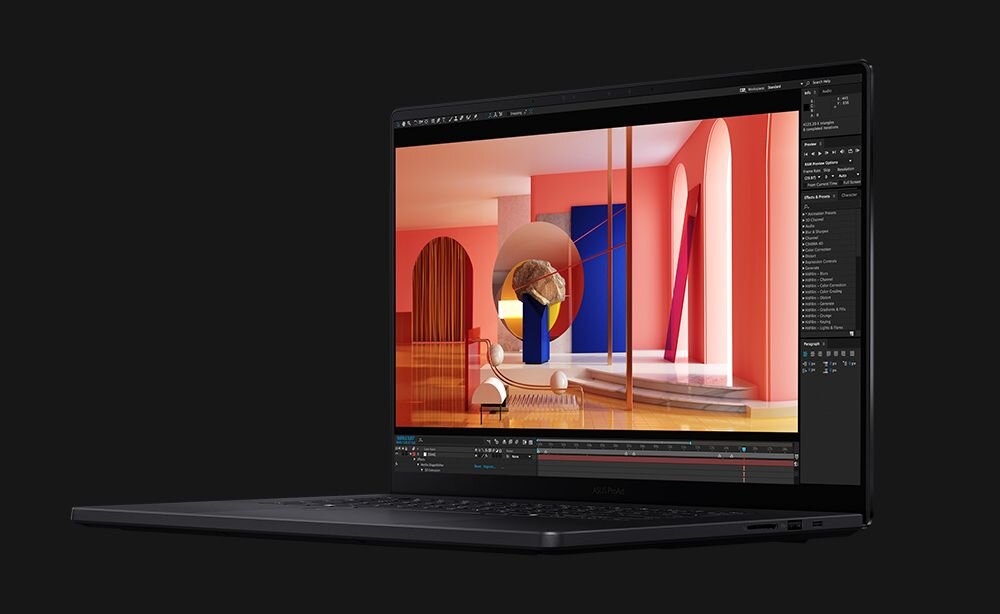 Laptop z wyświetlaczem pokazującym kolorową grafikę z elementami architektonicznymi i abstrakcyjnymi kształtami. Obudowa jest ciemna, a ekran otoczony cienką ramką.