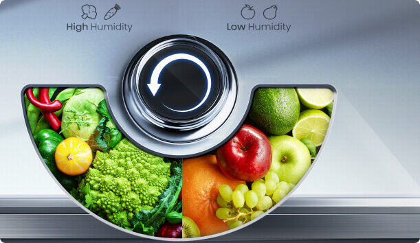 Obraz przedstawia pokrętło z ikoną strzałki, otoczone zdjęciami owoców i warzyw. Nad pokrętłem znajdują się napisy: \'High Humidity\' z ikoną warzyw oraz \'Low Humidity\' z ikoną owoców.