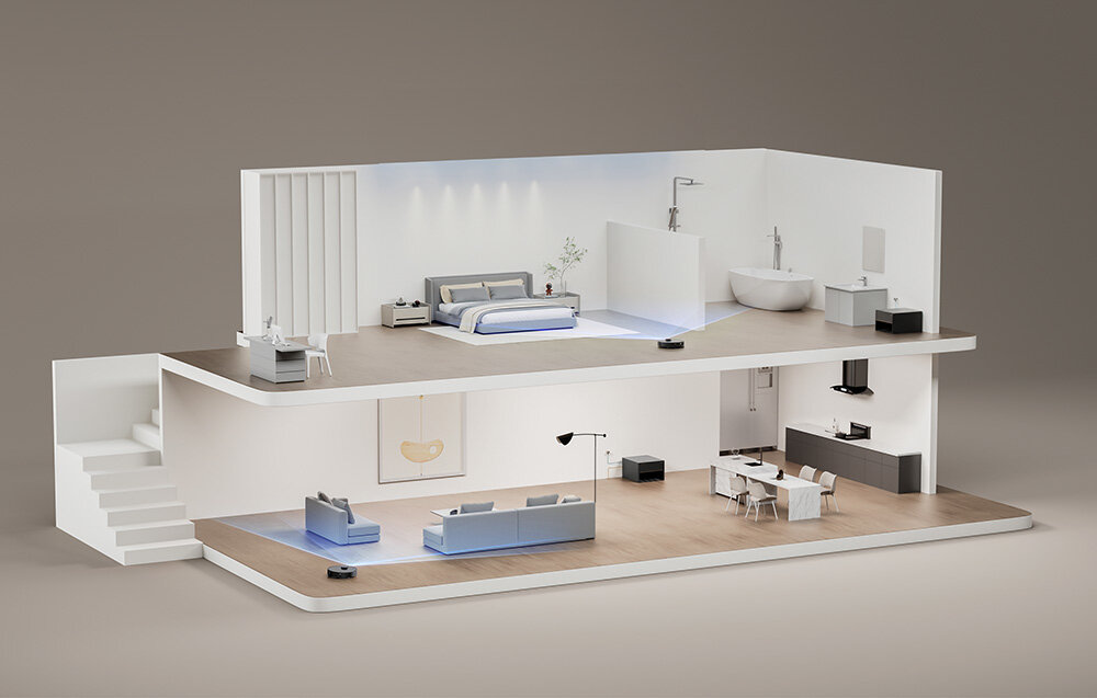 Dwupoziomowy model domu z nowoczesnym wnętrzem, w którym znajdują się meble i urządzenia. Na podłodze widoczny jest robot sprzątający.