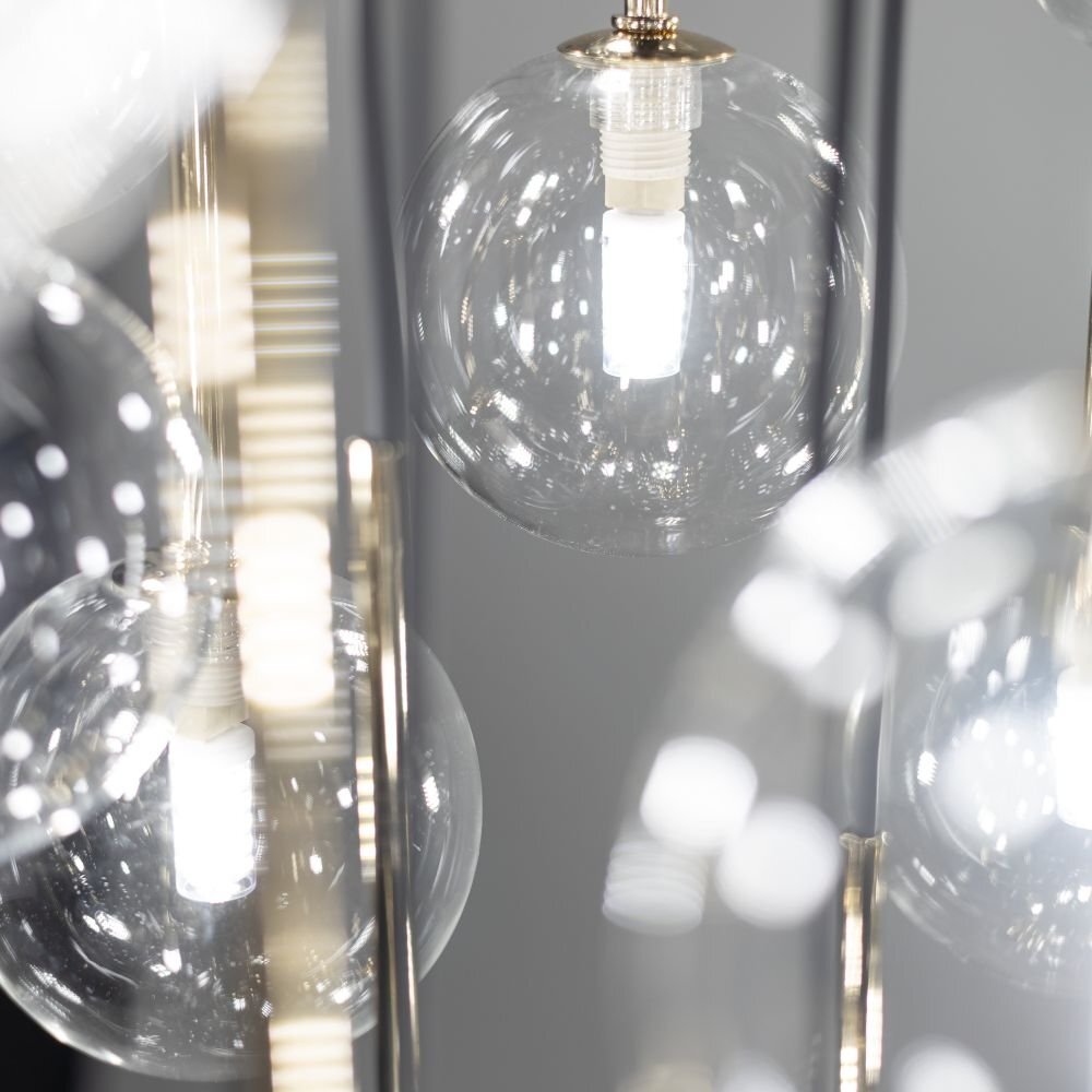 Zdjęcie przedstawia szklane klosze lampy wiszącej z widocznymi żarówkami wewnątrz. Elementy lampy mają czarno-złote wykończenie.