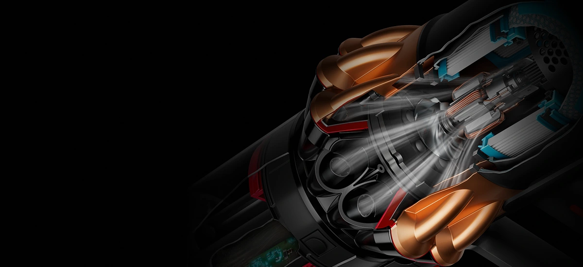 Widok przekroju silnika odkurzacza bezprzewodowego z zaznaczonym przepływem powietrza i elementami wewnętrznymi