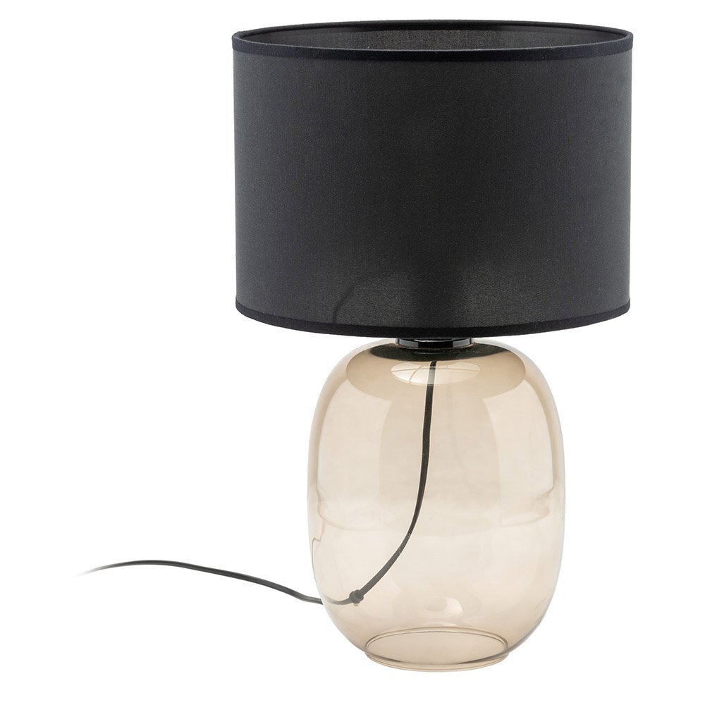 Lampa stołowa z czarnym abażurem i przezroczystą, szklaną podstawą. Przewód zasilający widoczny wewnątrz podstawy.