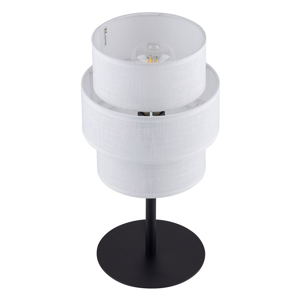 Lampa stołowa z białym, cylindrycznym abażurem i czarną, metalową podstawą. Na abażurze widoczne jest logo \'TK Lighting\'.