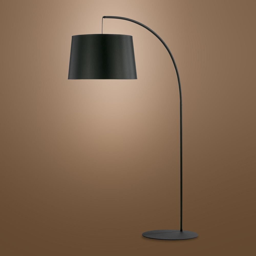 Czarna lampa podłogowa z zakrzywionym ramieniem i dużym, cylindrycznym kloszem. Lampa stoi na okrągłej podstawie, a tło jest jednolite i brązowe.