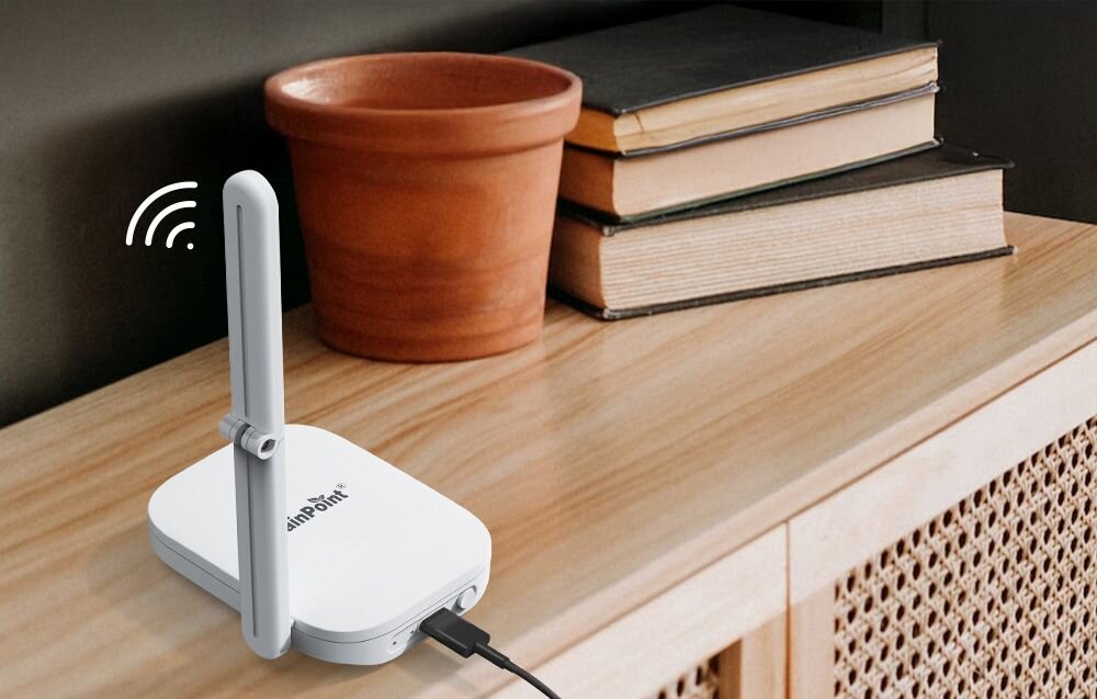 Inteligentny Termohigrometr RAINPOINT Smart+, RF 433 MHz, zasięg 100 m, komunikacja, stabilność, Biała stacja bazowa z podniesioną anteną i kablem USB, ustawiona na drewnianej komodzie obok książek.