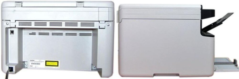 Obraz przedstawia dwa widoki urządzenia wielofunkcyjnego w kolorze szarym. Z tyłu widoczne są otwory wentylacyjne i gniazdo zasilania, a z boku otwarta taca na papier.