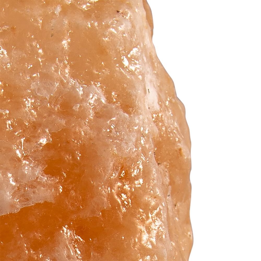 Zbliżenie na powierzchnię lampy solnej o nieregularnej, chropowatej strukturze i pomarańczowym kolorze.