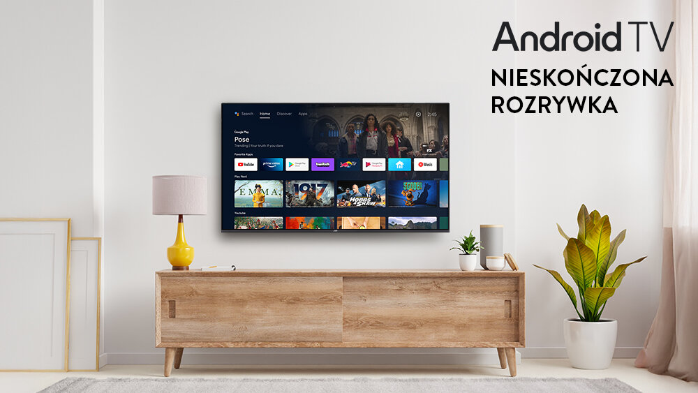 Telewizor JVC LT-40VQF540A - Centrum rozrywki z Android TV 11, platformy streamingowe, telewizor zawieszony na ścianie nad komodą w pomieszczeniu