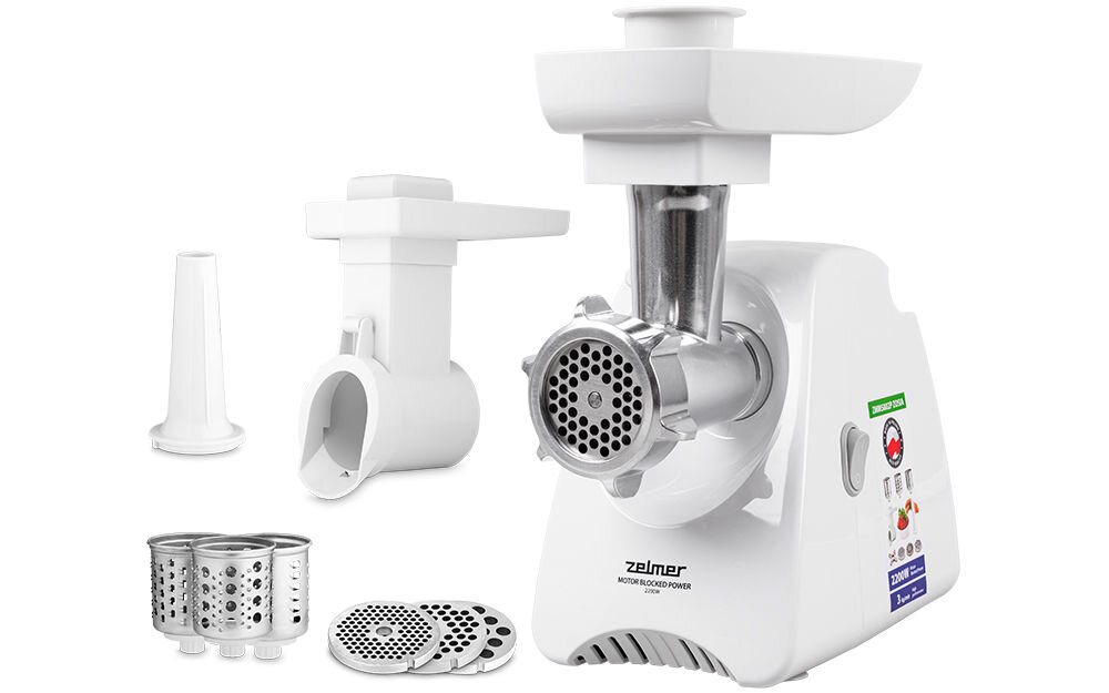 Na zdjęciu znajduje się maszynka do mięsa marki Zelmer z różnymi akcesoriami, w tym sitkami i nasadkami. Produkt jest biały z metalowymi elementami i widocznym logo Zelmer na obudowie.