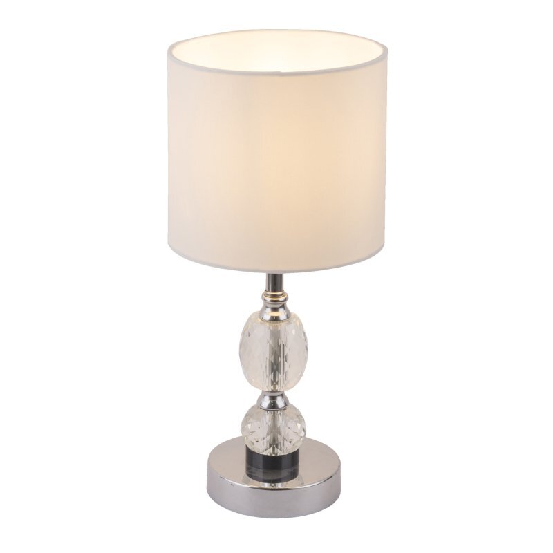 Lampa stołowa z białym abażurem i chromowaną podstawą ozdobioną kryształowymi elementami. Lampa posiada wyłącznik i jest przeznaczona na żarówkę E14 o mocy 40W.