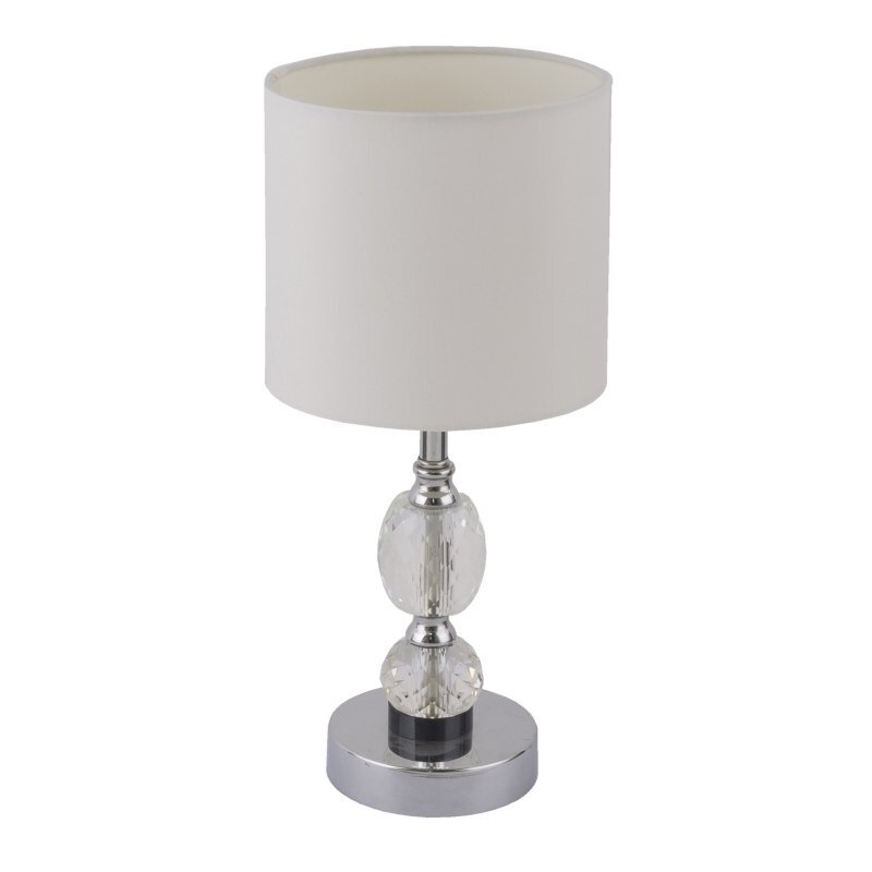 Lampa stołowa z białym abażurem i chromowaną podstawą ozdobioną kryształowymi elementami. Posiada wyłącznik i jest przeznaczona na żarówkę E14 o mocy 40W.